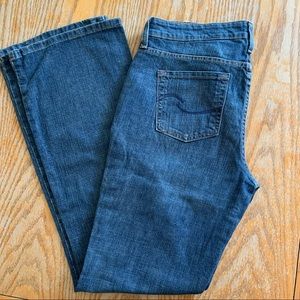 Med blue low rise bootcut long length signature jeans by Levi’s Strauss.